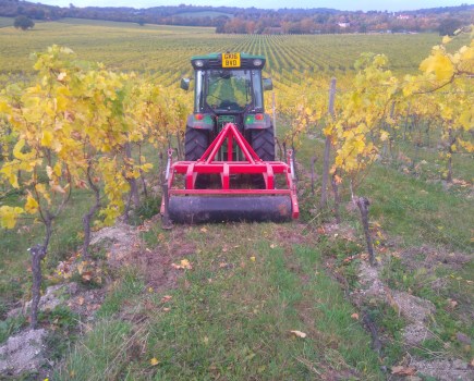 Vineyard cultivator in field