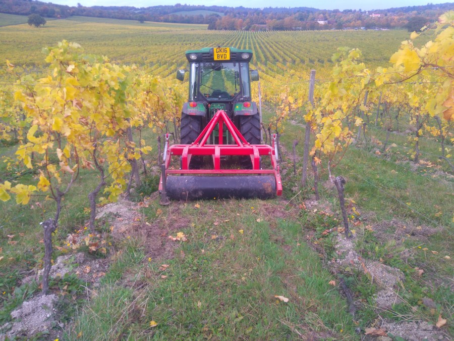 Vineyard cultivator in field