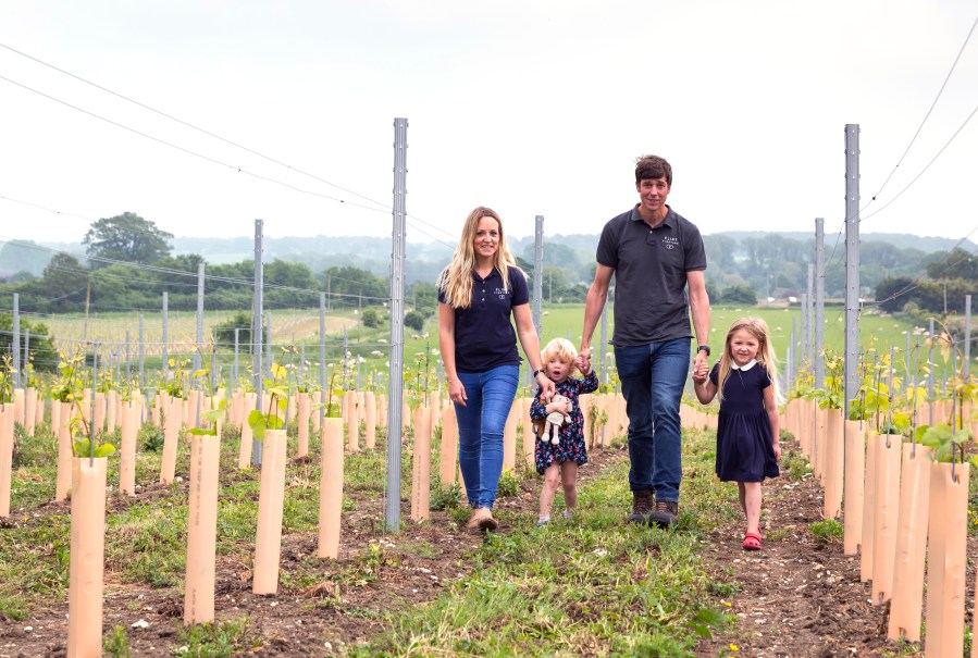 Husband, wife, 2 children in vineyard