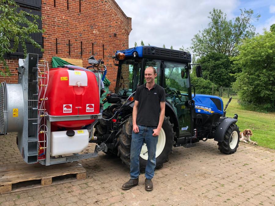 Person in front of a sprayer